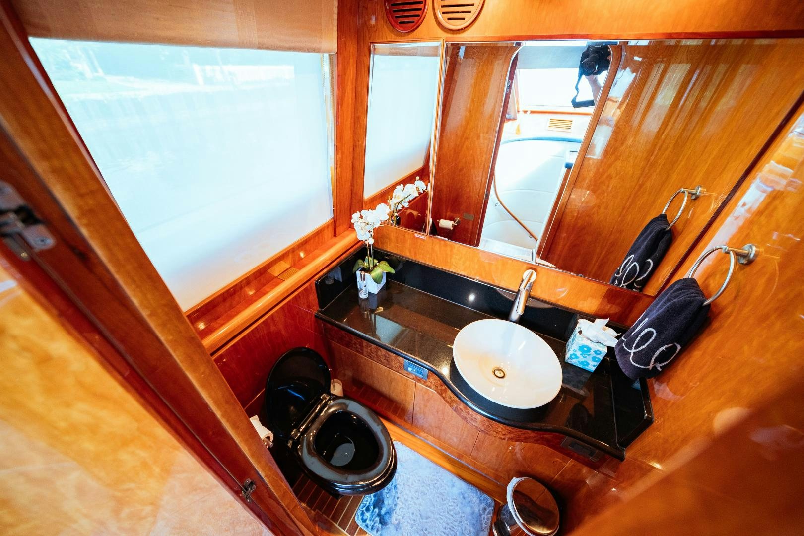 a bathroom with a sink and a large mirror aboard ANDIAMO Yacht for Sale