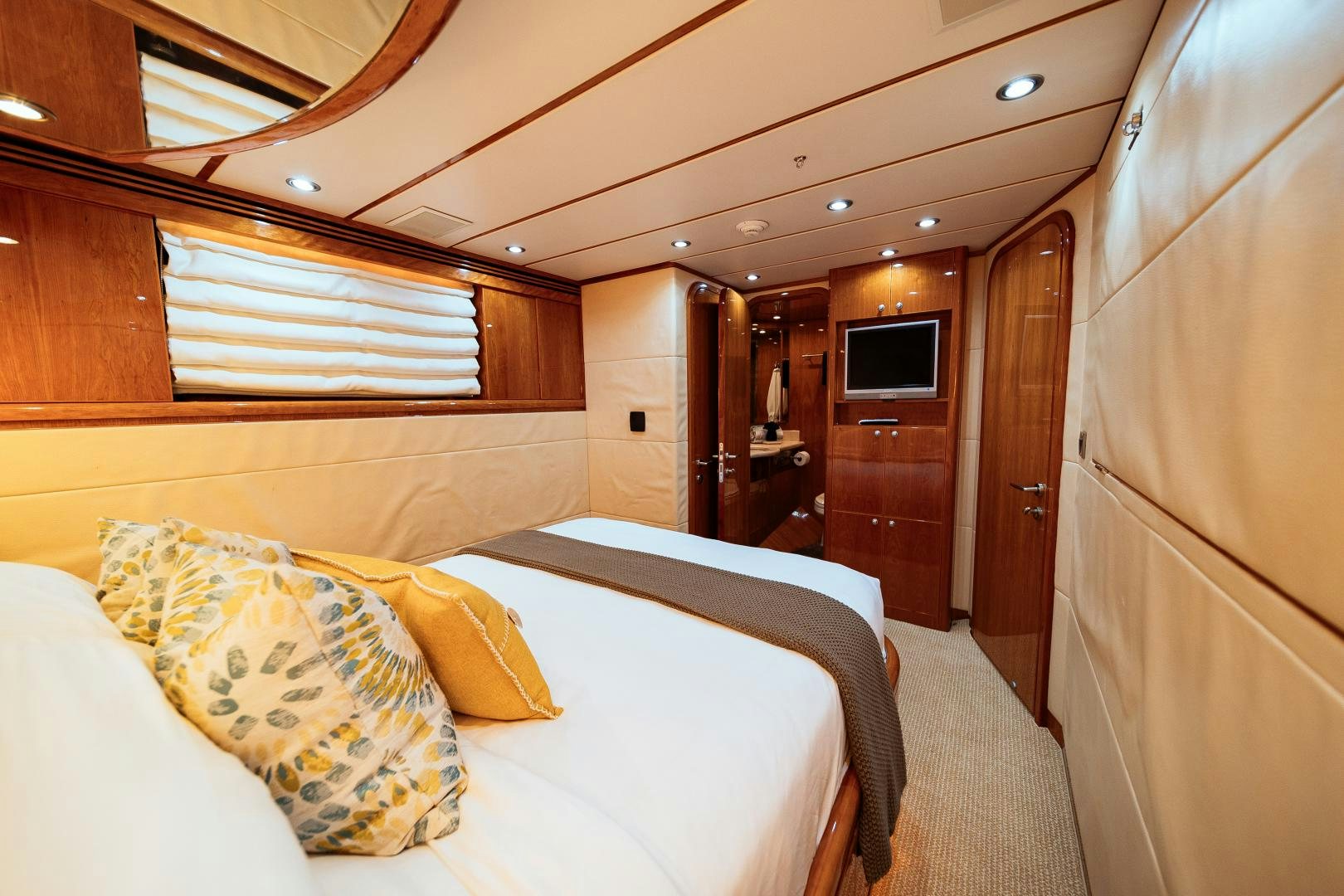 a room with a bed and a television aboard ANDIAMO Yacht for Sale