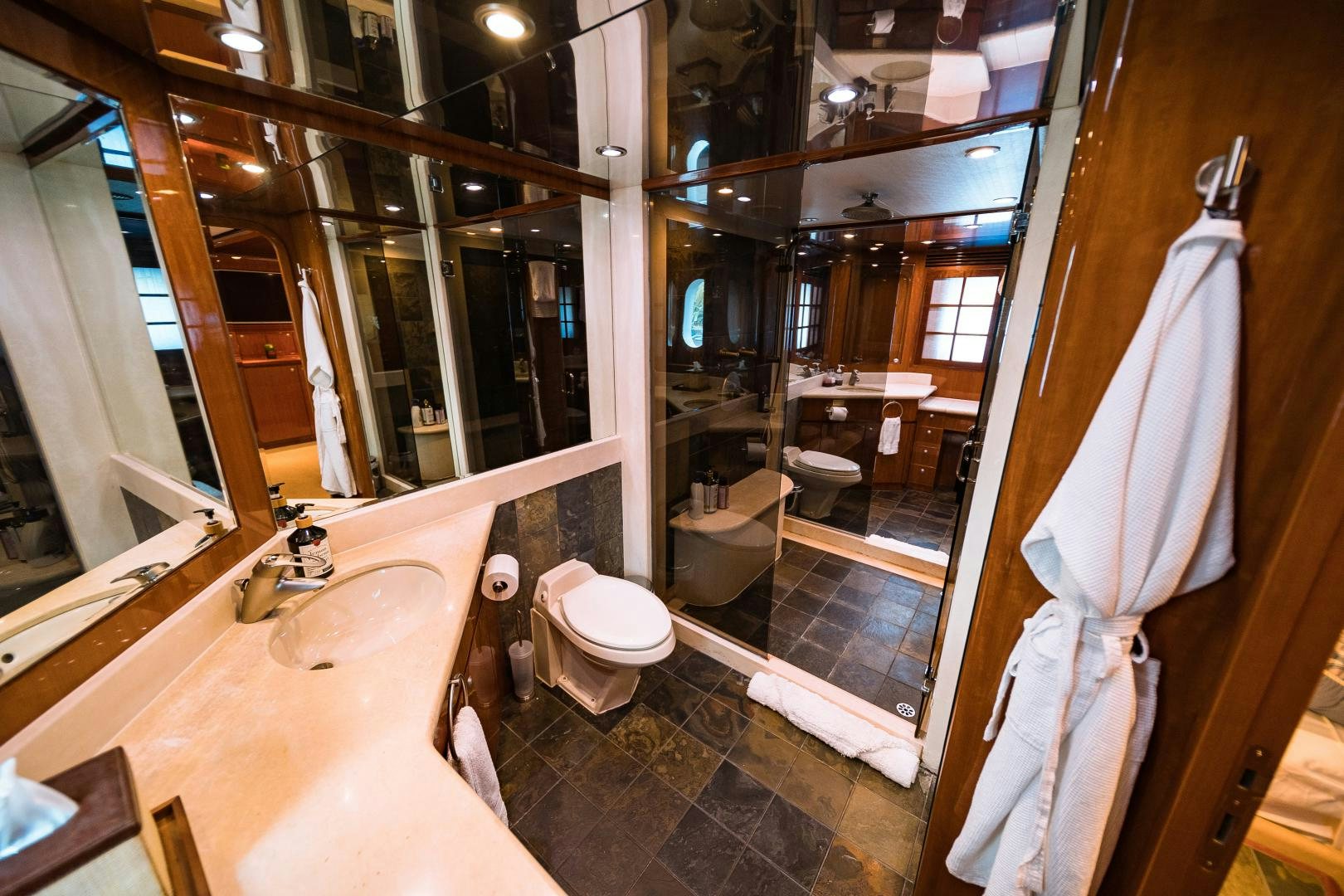 a bathroom with a large mirror aboard ANDIAMO Yacht for Sale