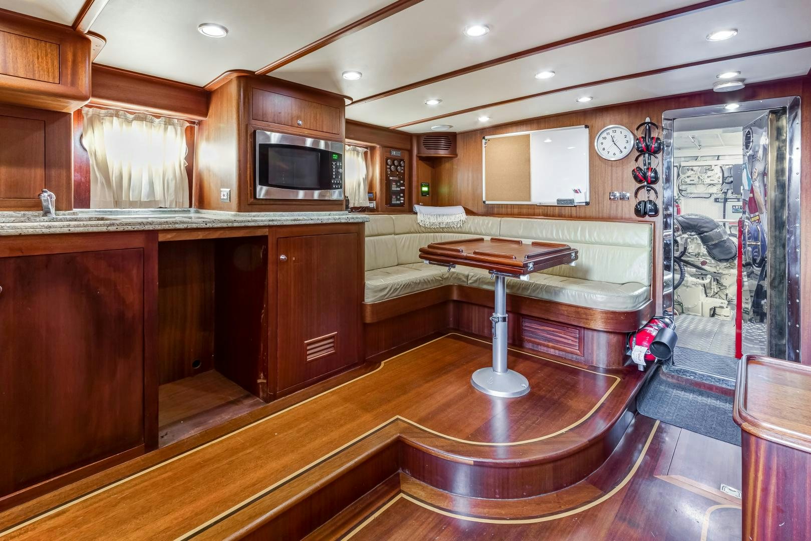a large kitchen with a table and chairs aboard CHANSON II Yacht for Sale