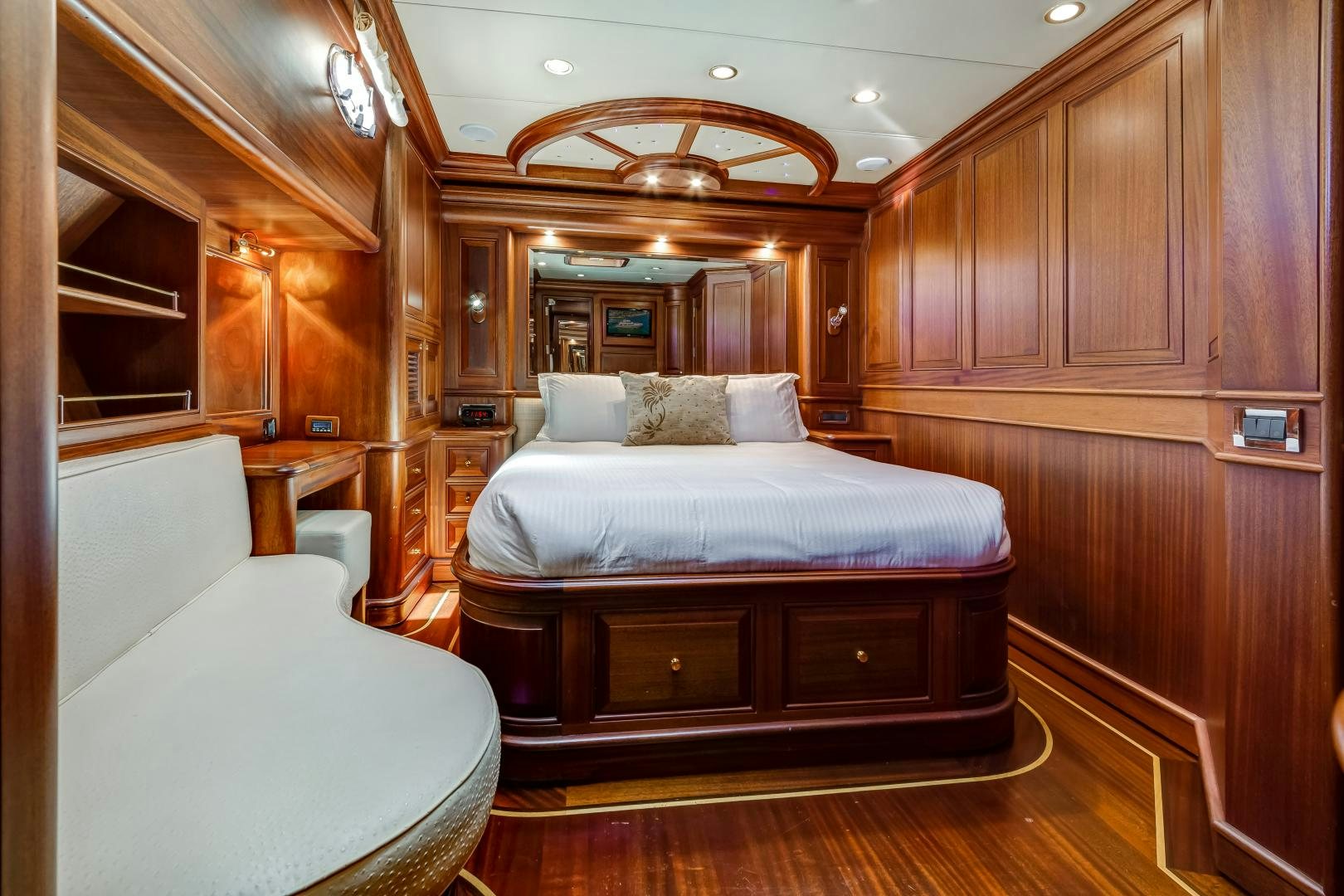 a bedroom with a bed and a couch aboard CHANSON II Yacht for Sale