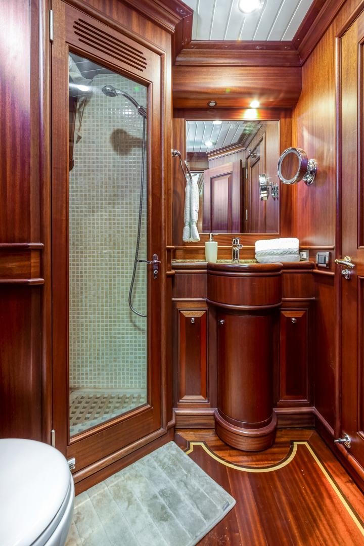 a bathroom with a glass shower aboard CHANSON II Yacht for Sale
