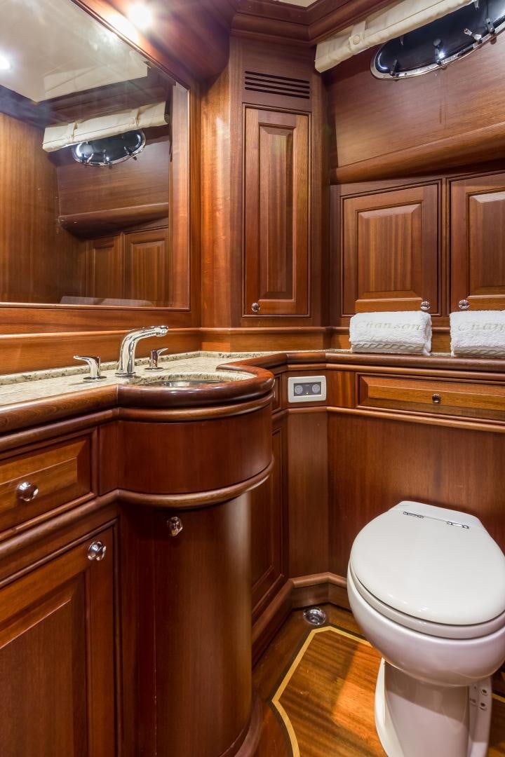 a bathroom with a toilet sink and cabinets aboard CHANSON II Yacht for Sale