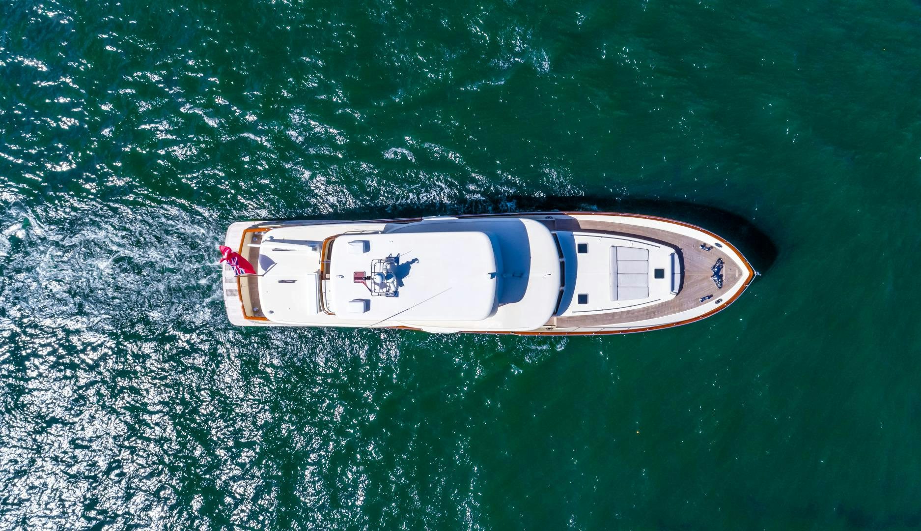 a white and red boat in the water aboard CHANSON II Yacht for Sale