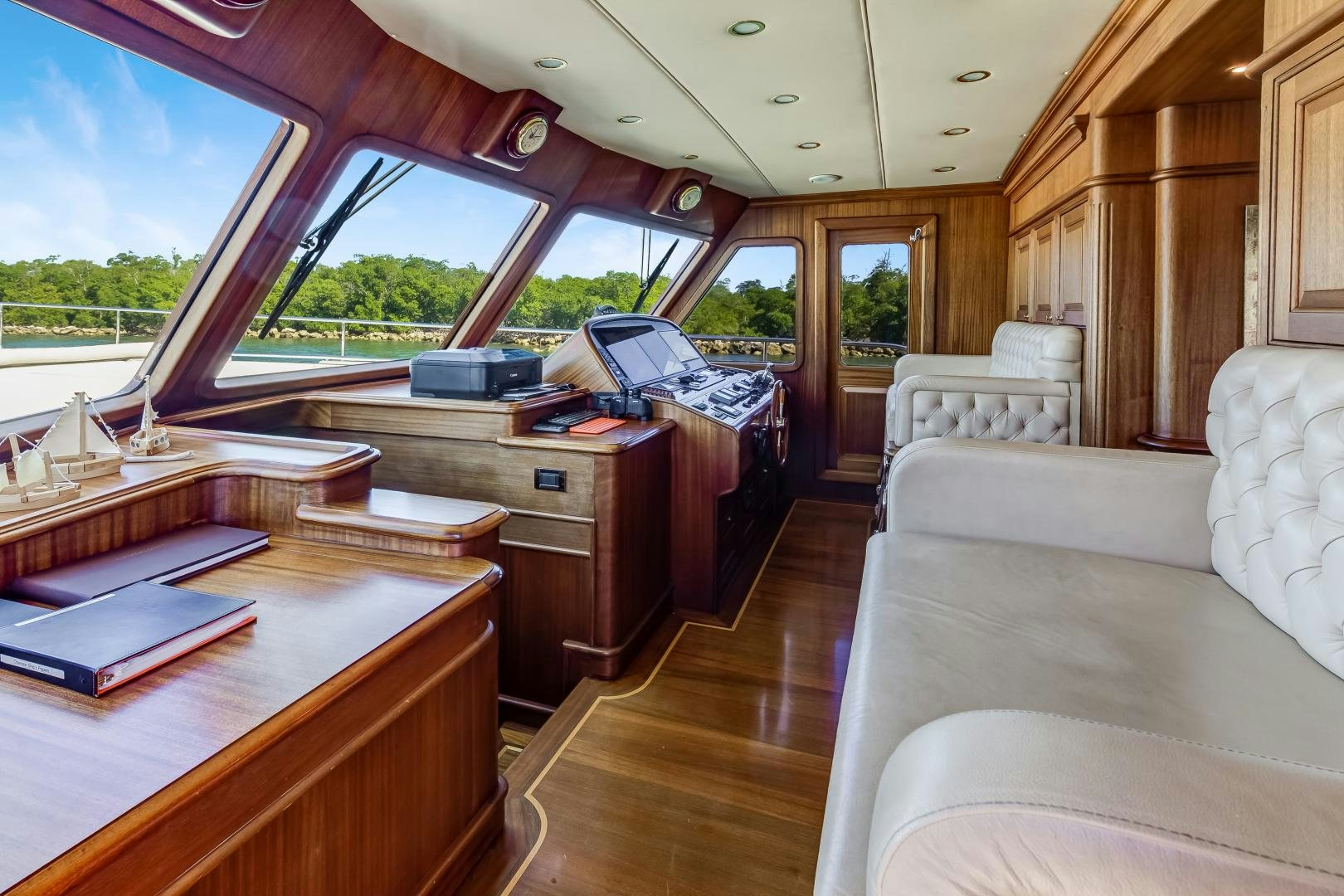 a room with a bed and desk aboard CHANSON II Yacht for Sale