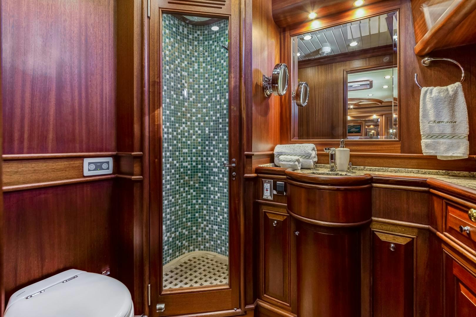 a bathroom with a shower and sink aboard CHANSON II Yacht for Sale