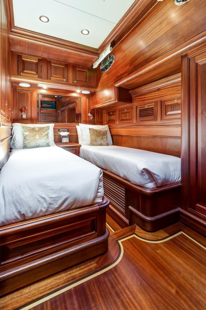 a couple of beds in a wood room aboard CHANSON II Yacht for Sale