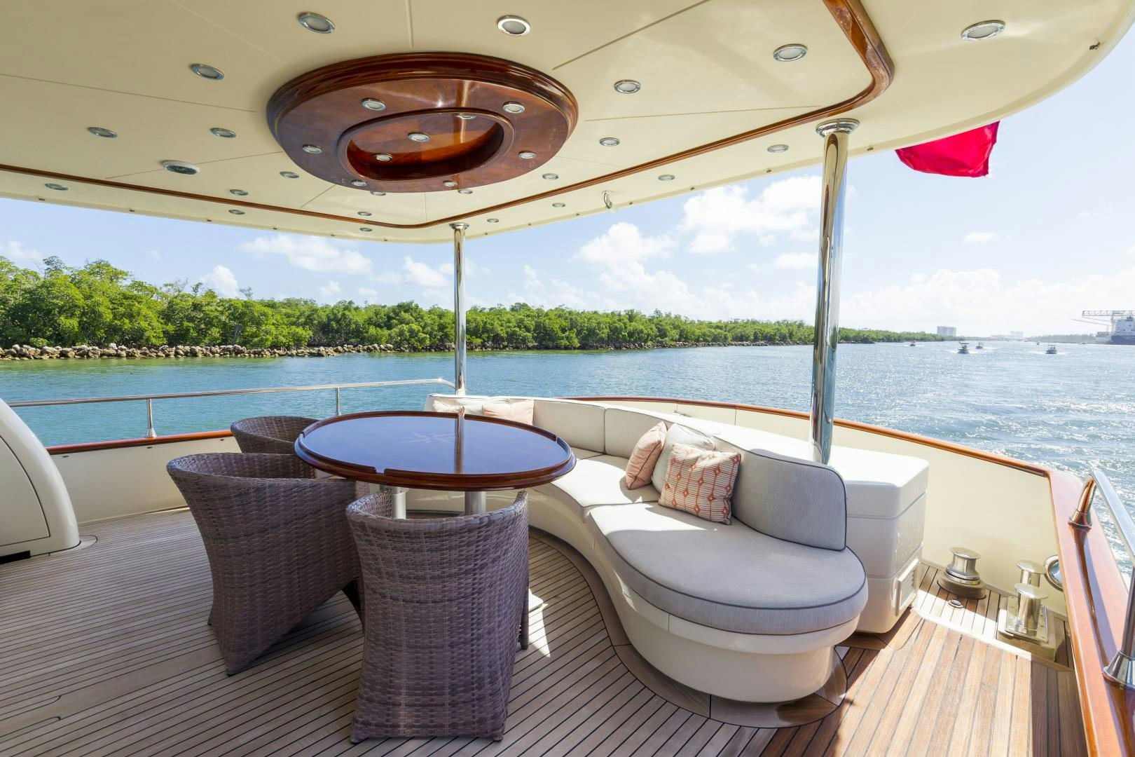 a lounge chair on a deck overlooking a body of water aboard CHANSON II Yacht for Sale