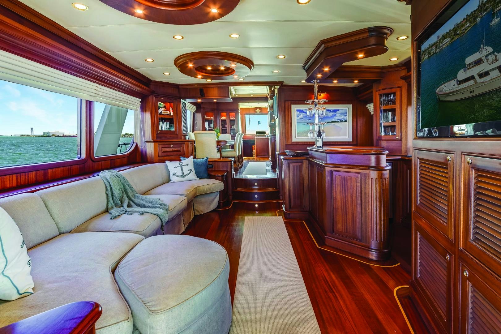 a living room with a couch and a television aboard CHANSON II Yacht for Sale