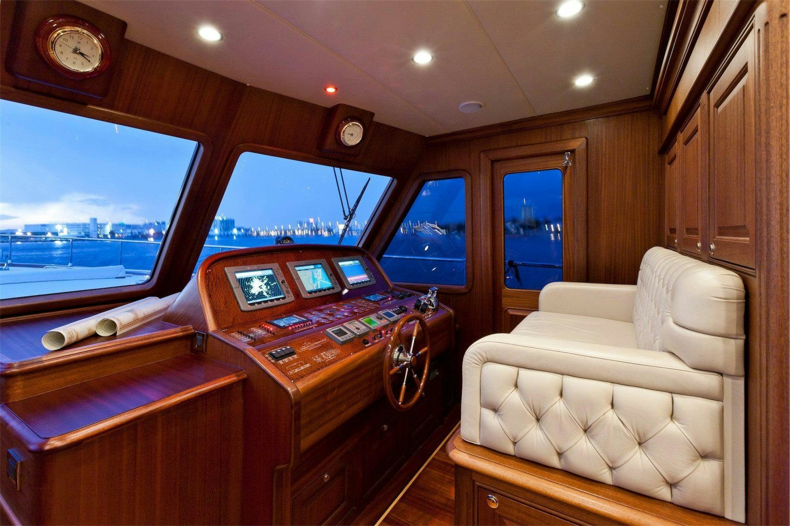 a room with a couch and a table with a large window aboard NEW VICEM 97 CRUISER Yacht for Sale