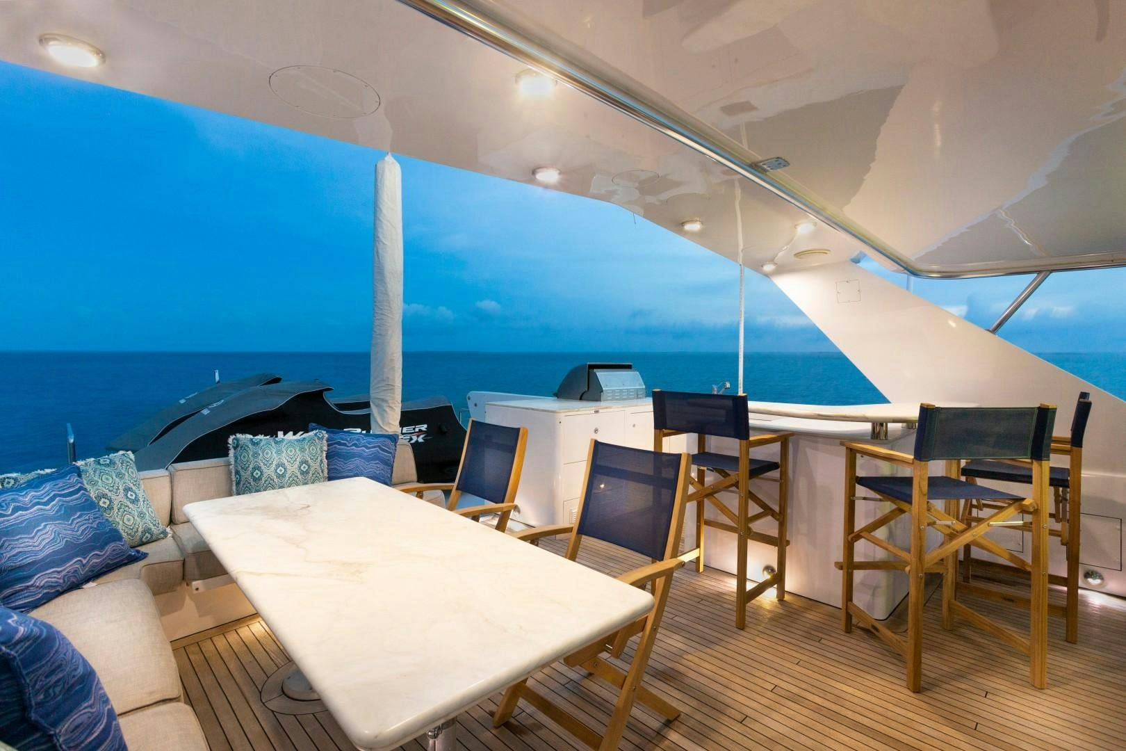 a pool with tables and chairs aboard CRU Yacht for Sale