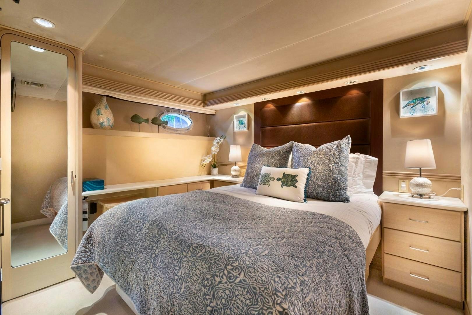 a bed with a white comforter and pillows in a bedroom aboard CRU Yacht for Sale