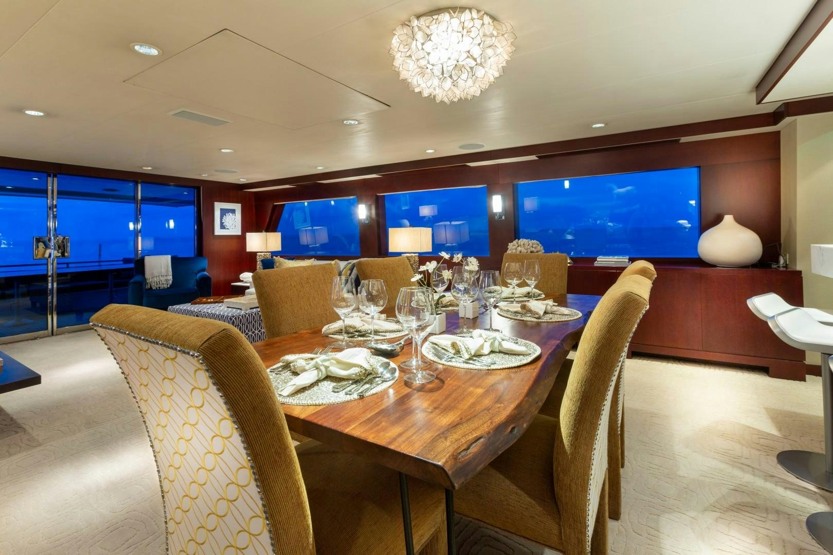 a dining room with a table and chairs aboard CRU Yacht for Sale