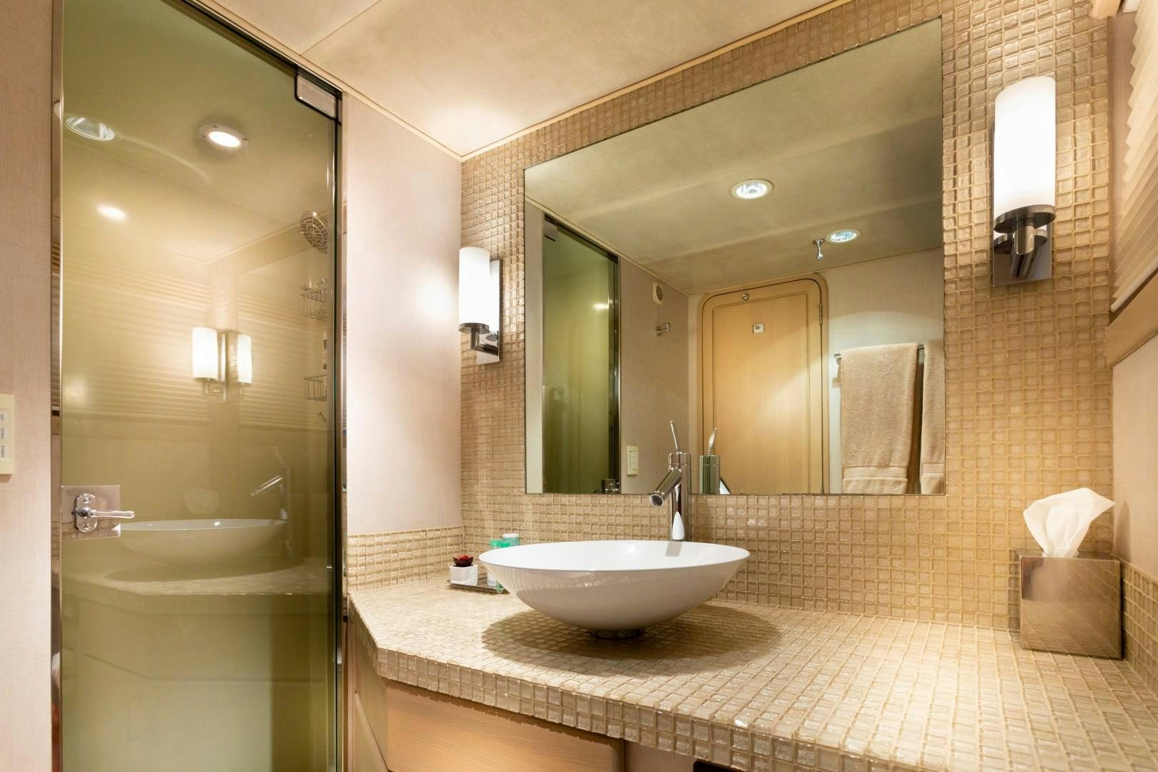 a bathroom with a large mirror aboard CRU Yacht for Sale