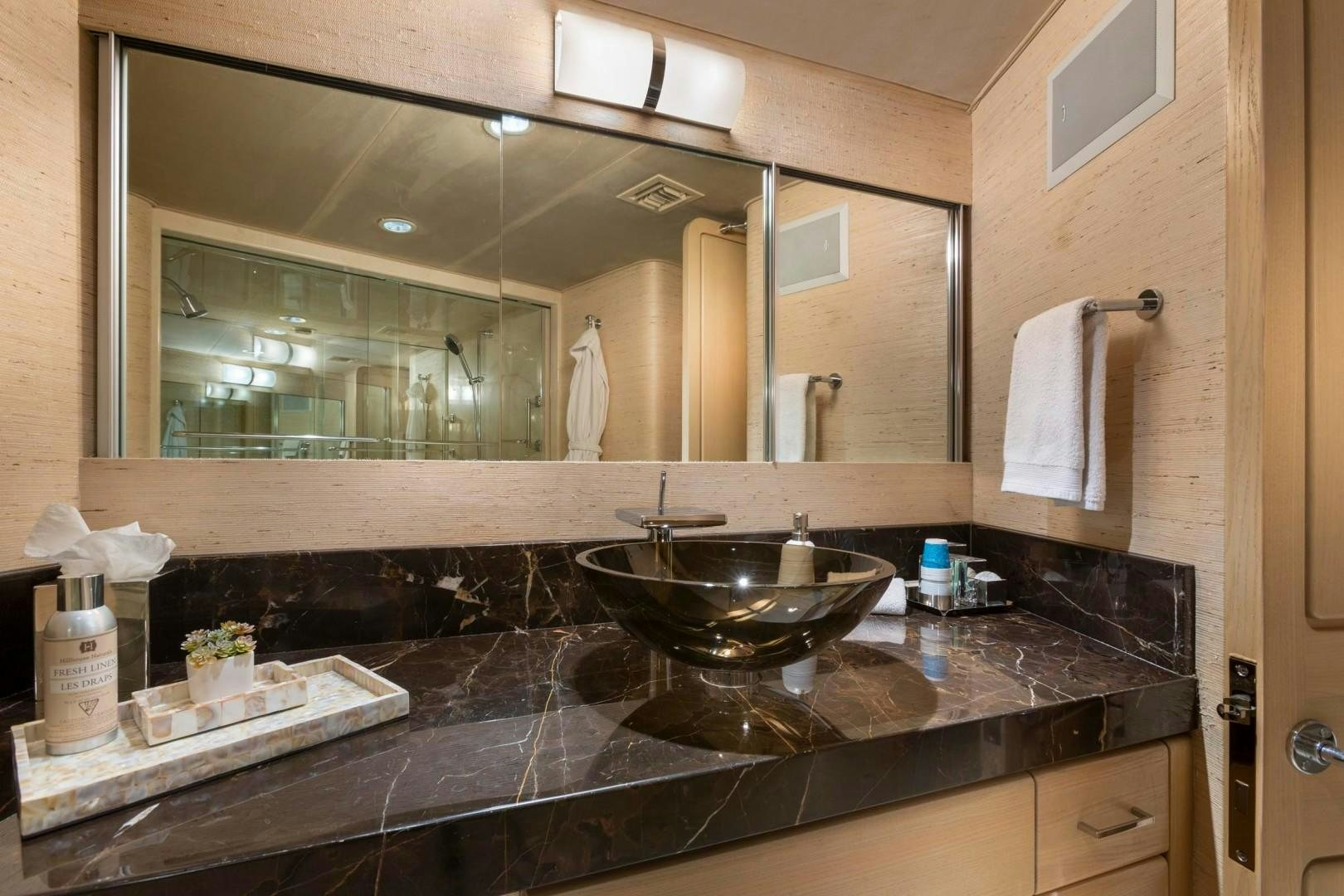 a bathroom with a large mirror aboard CRU Yacht for Sale