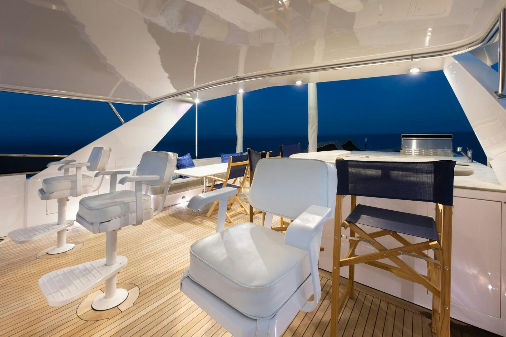 a room with chairs and tables aboard CRU Yacht for Sale