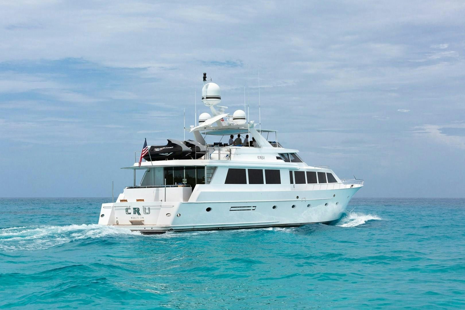 a white boat on the water aboard CRU Yacht for Sale