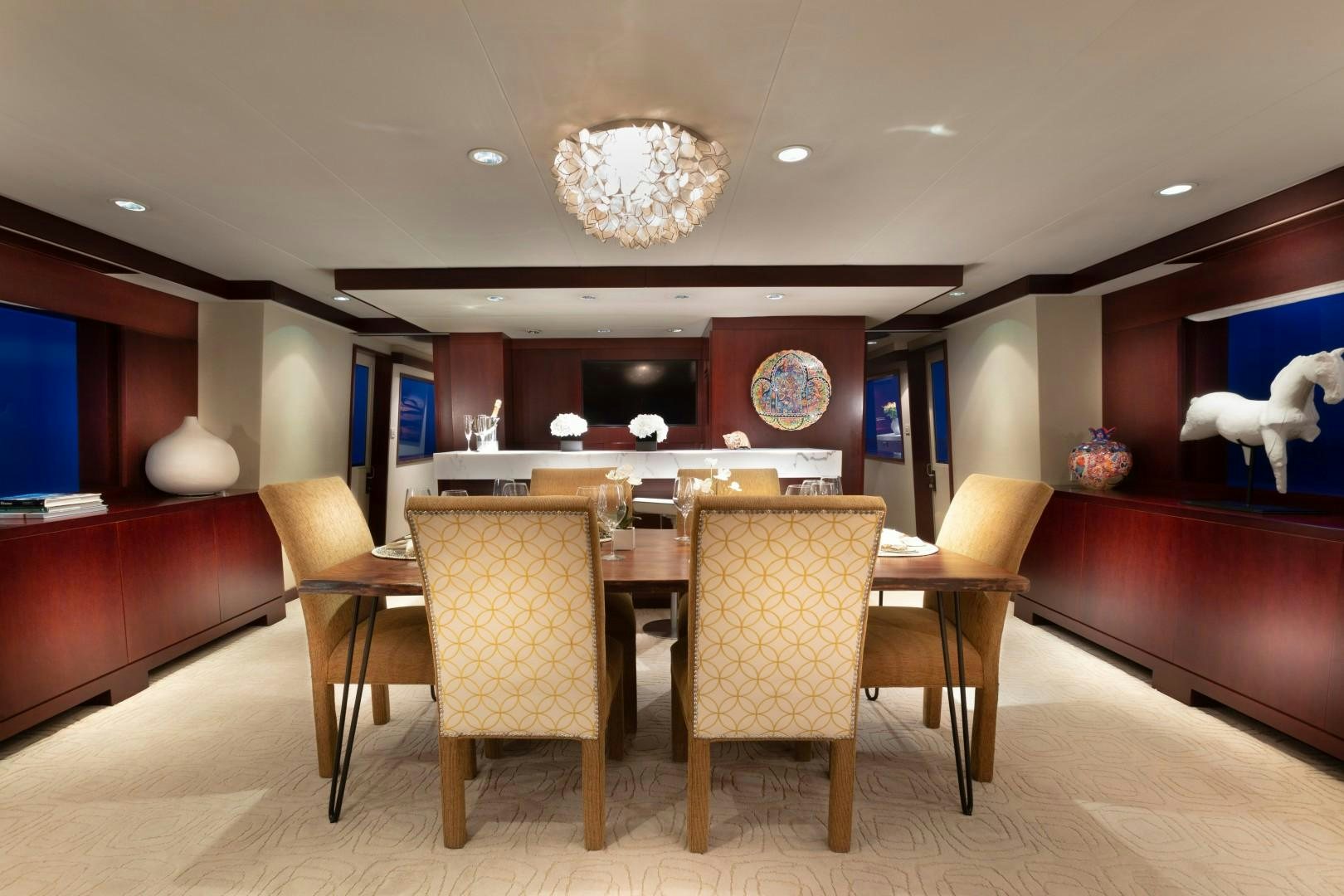 a room with a table and chairs aboard CRU Yacht for Sale