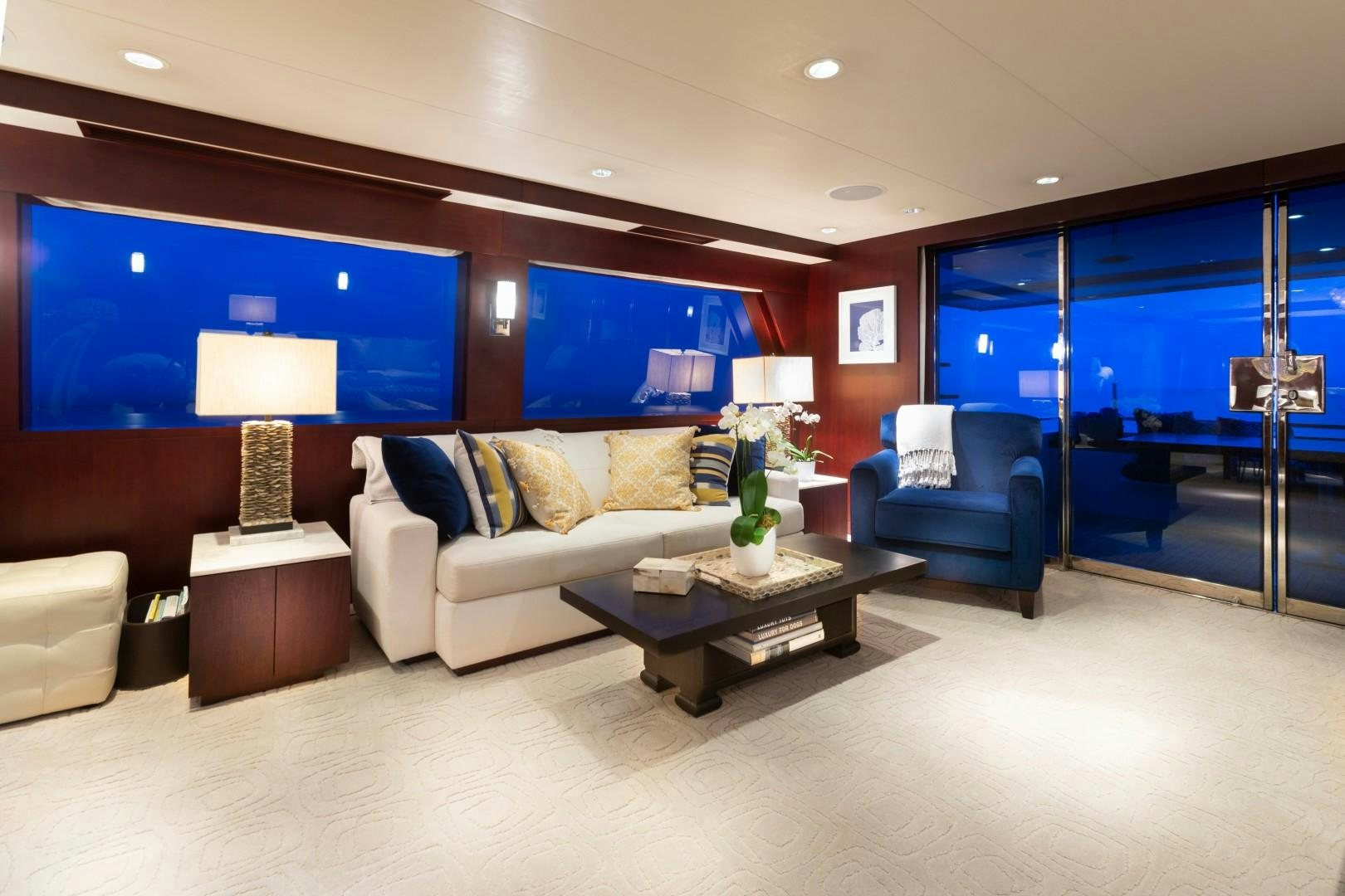 a living room with a large window aboard CRU Yacht for Sale
