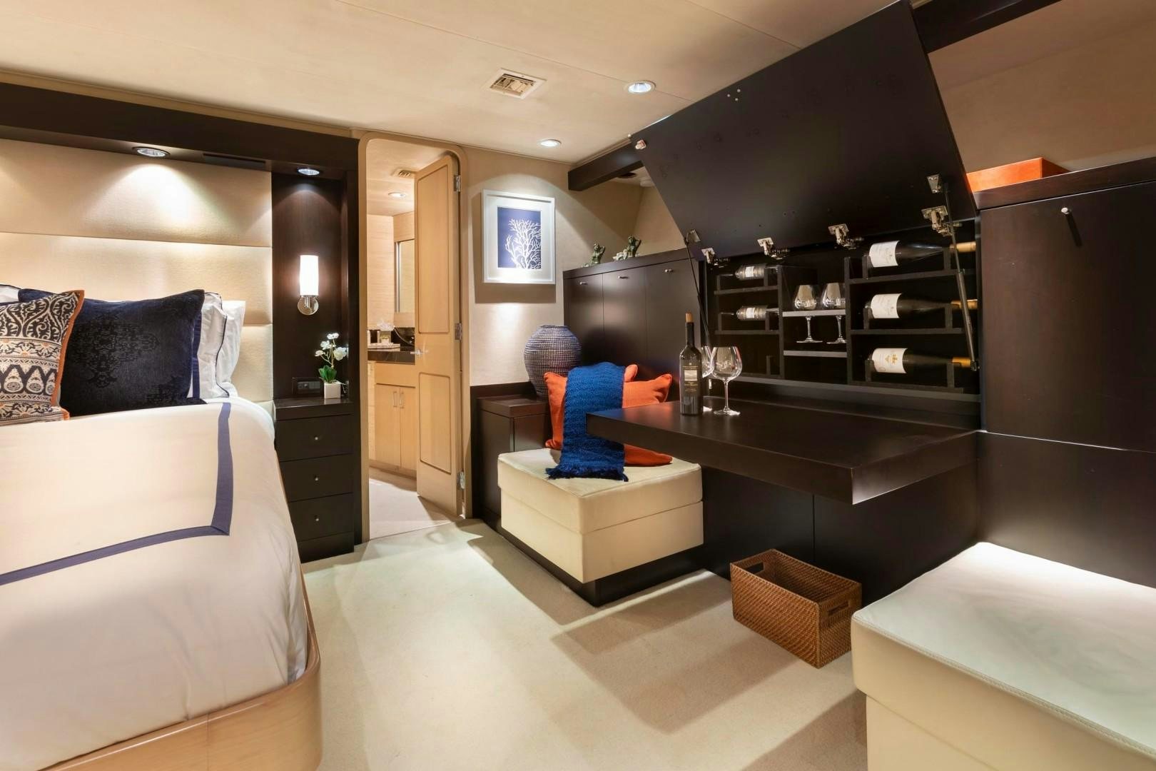 a room with a table and a couch aboard CRU Yacht for Sale