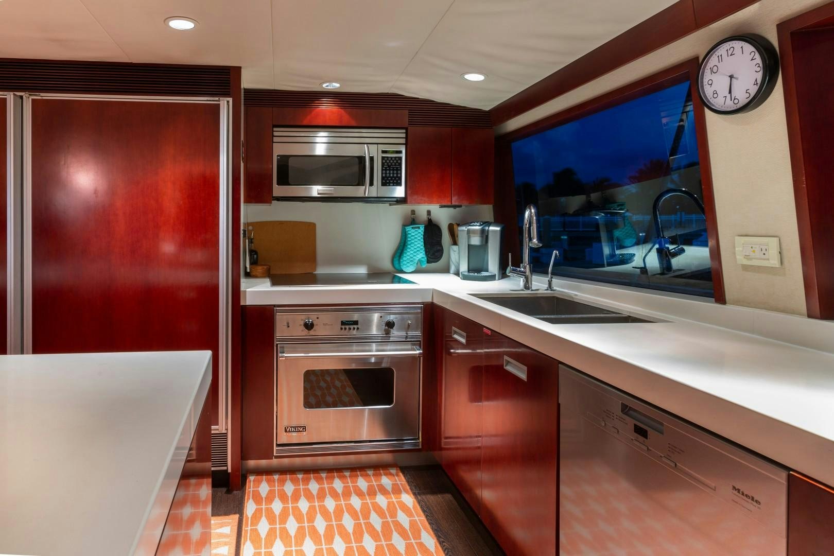a kitchen with red cabinets aboard CRU Yacht for Sale
