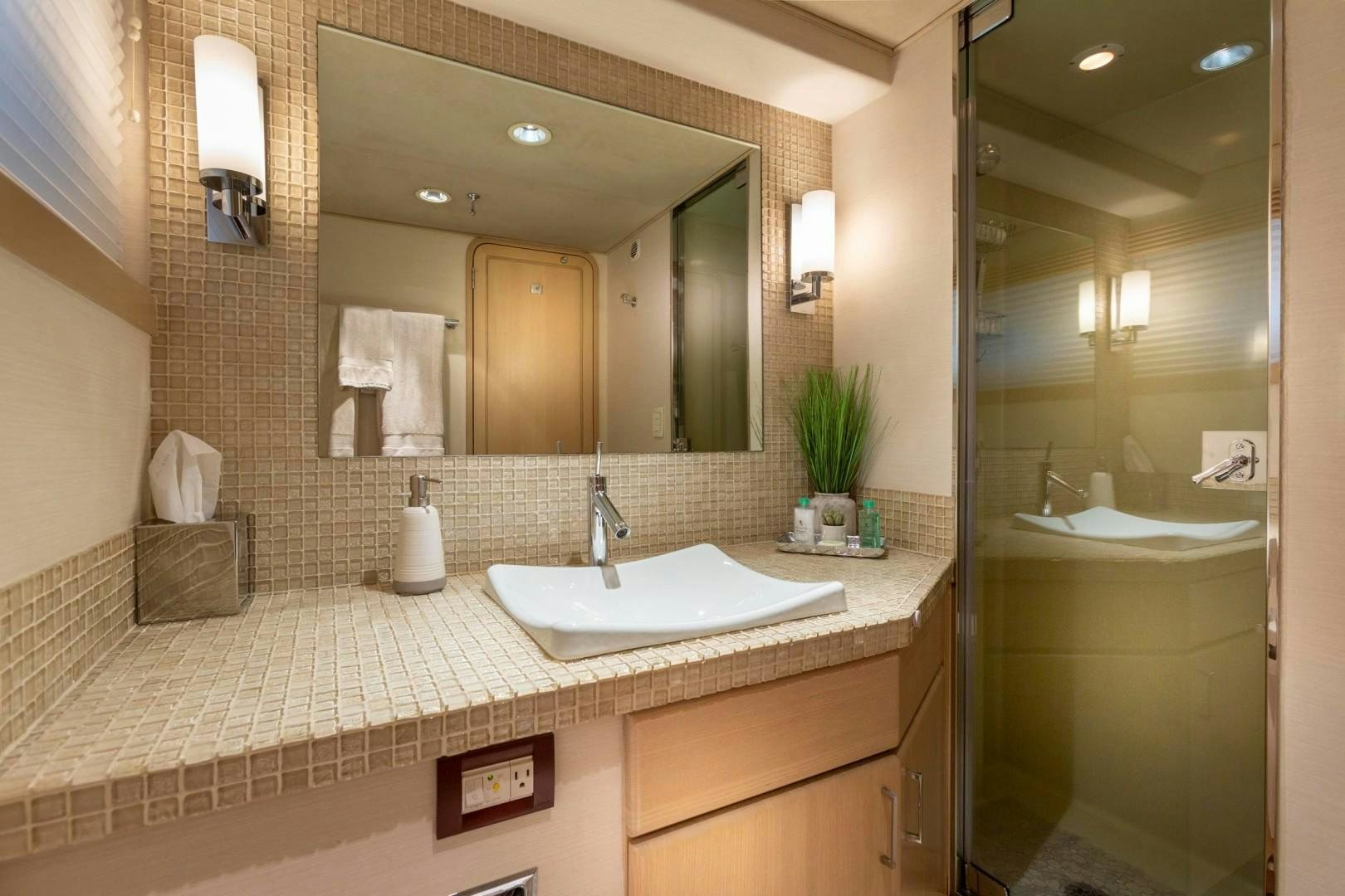 a bathroom with a large mirror aboard CRU Yacht for Sale