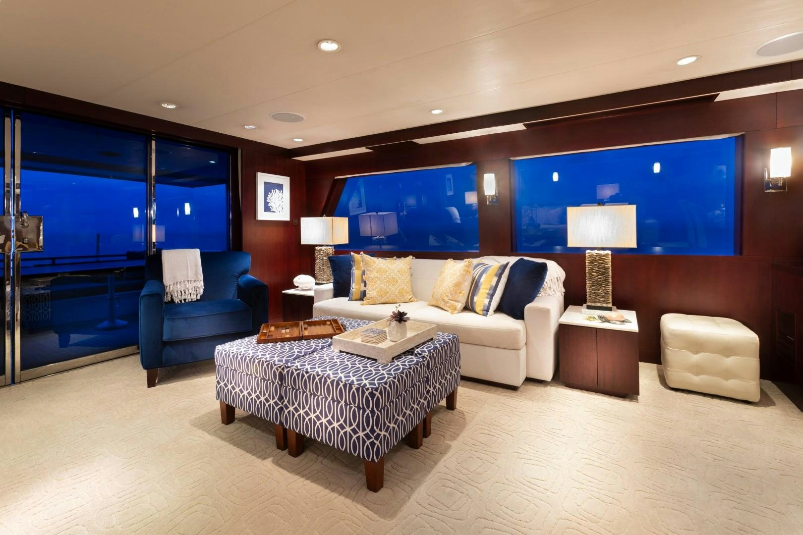 a living room with a large blue screen aboard CRU Yacht for Sale
