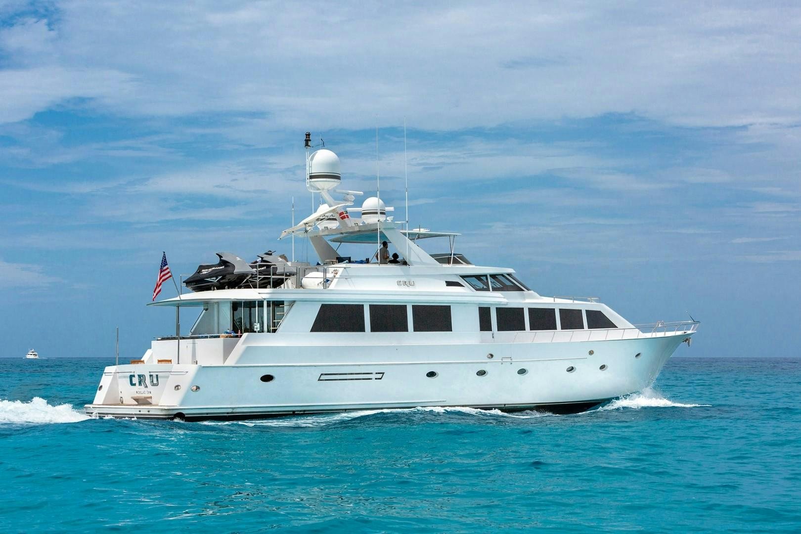 a white boat in the water aboard CRU Yacht for Sale