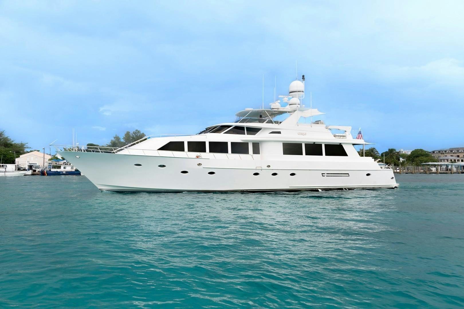 a white yacht in the water aboard CRU Yacht for Sale