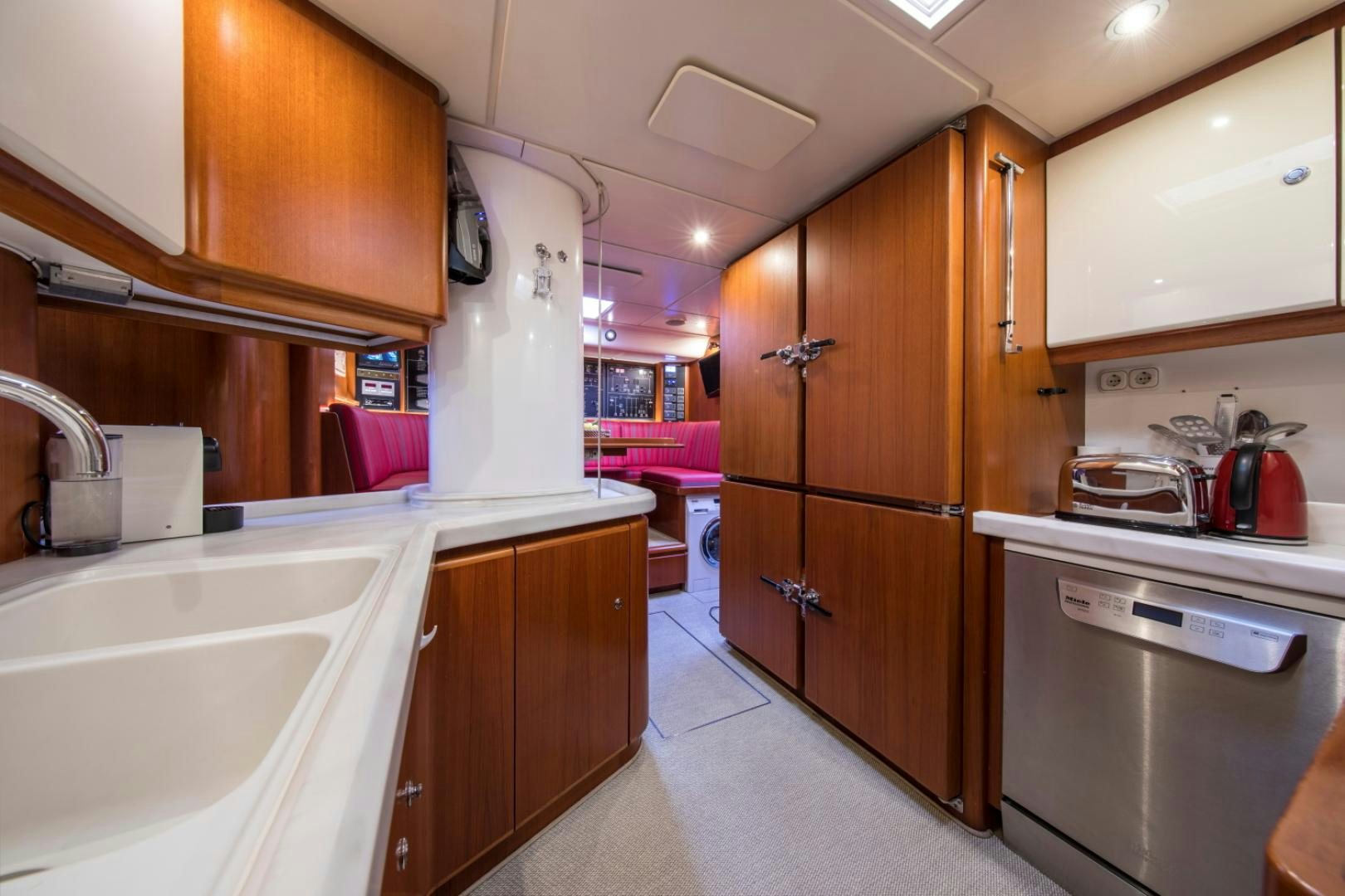 a kitchen with wooden cabinets aboard ALTA MAREA Yacht for Sale