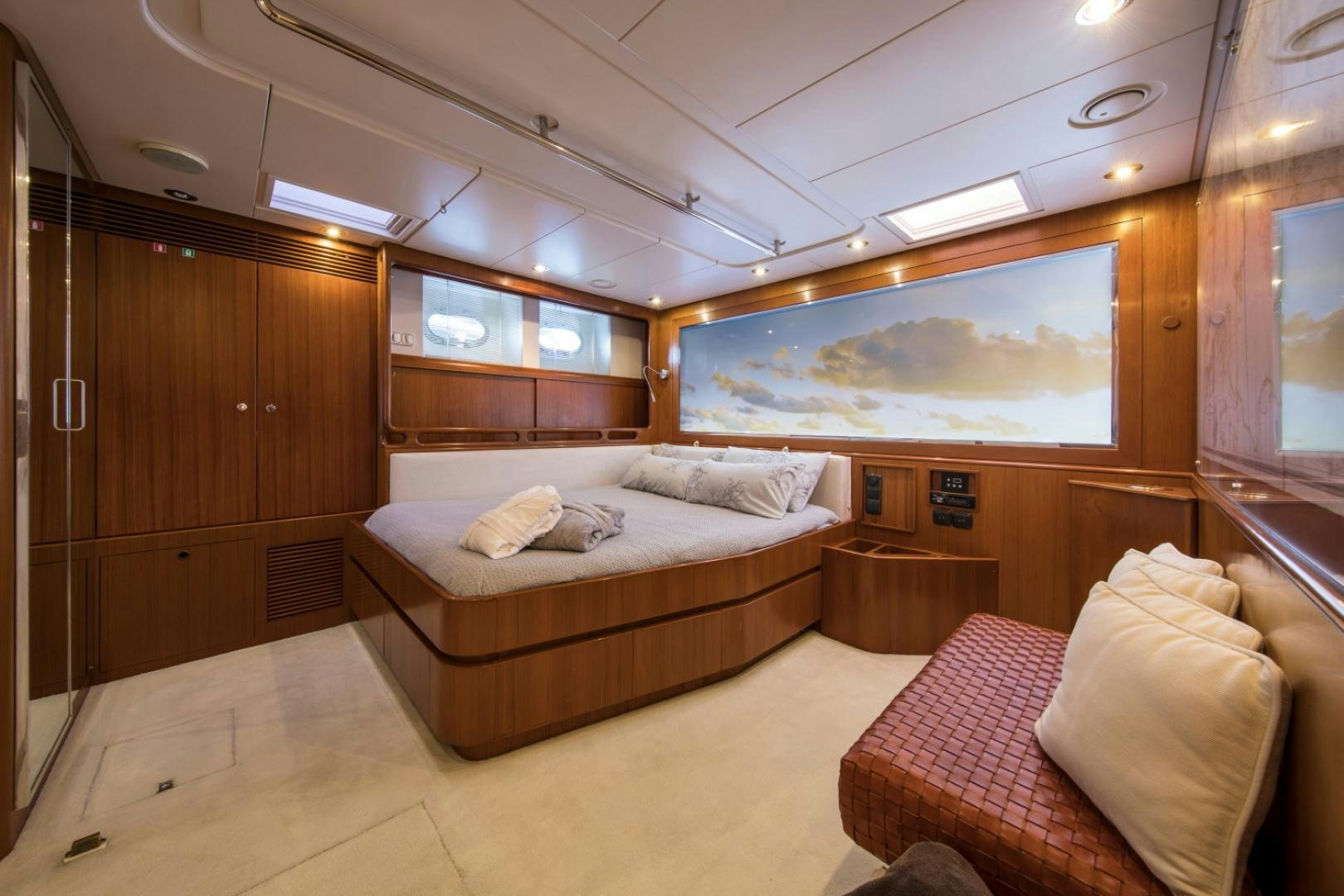 a room with a bed and a mirror aboard ALTA MAREA Yacht for Sale