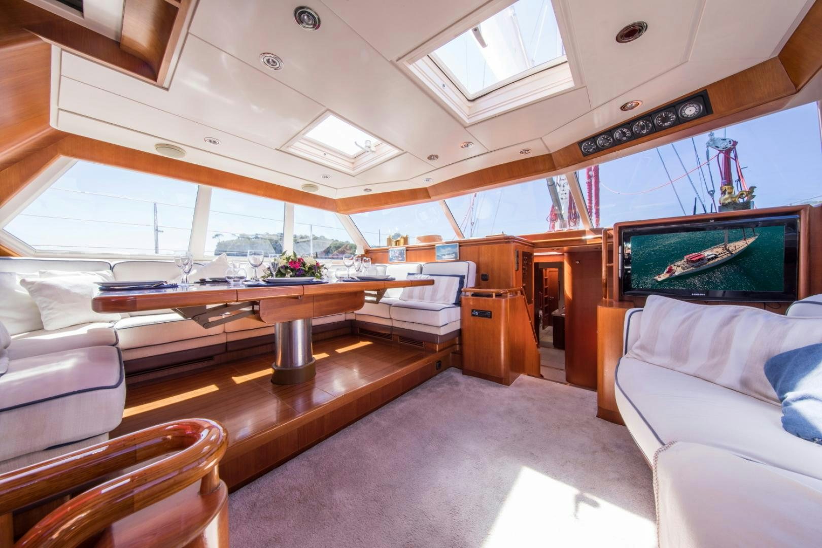 a room with a table and couch aboard ALTA MAREA Yacht for Sale