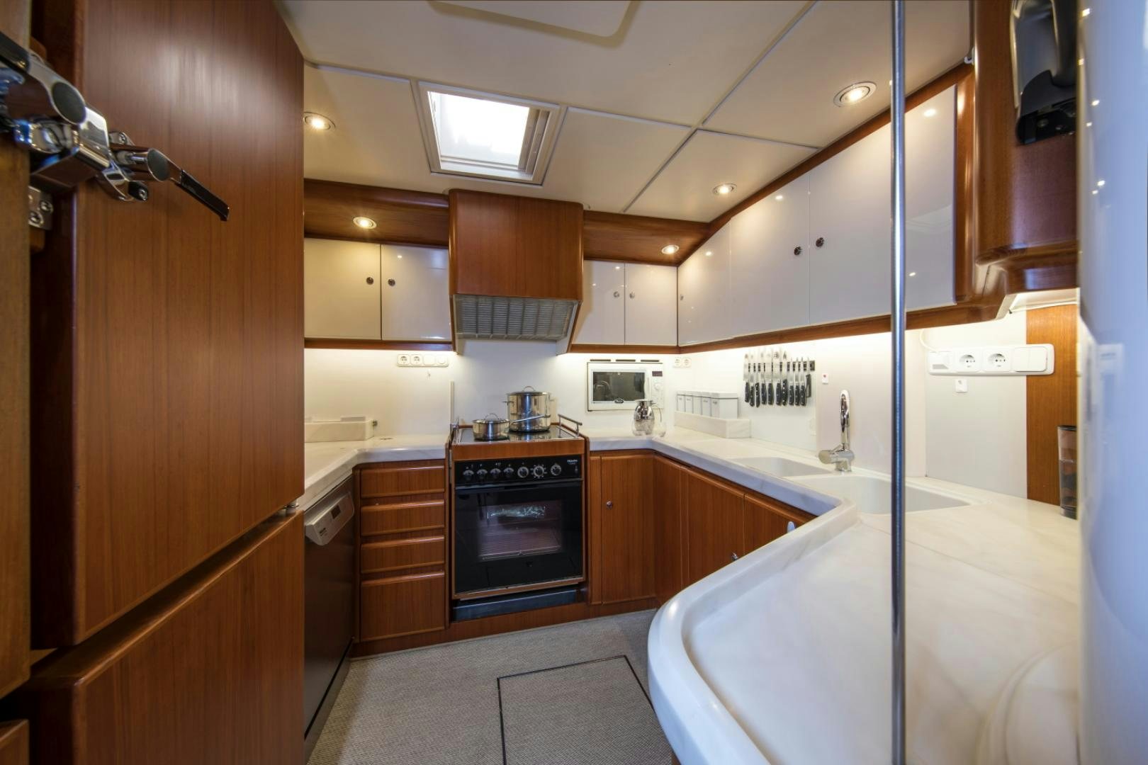 a kitchen with a stove and cabinets aboard ALTA MAREA Yacht for Sale
