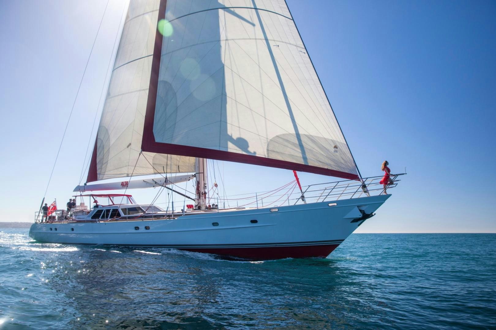 a large white boat with a sail on the water aboard ALTA MAREA Yacht for Sale