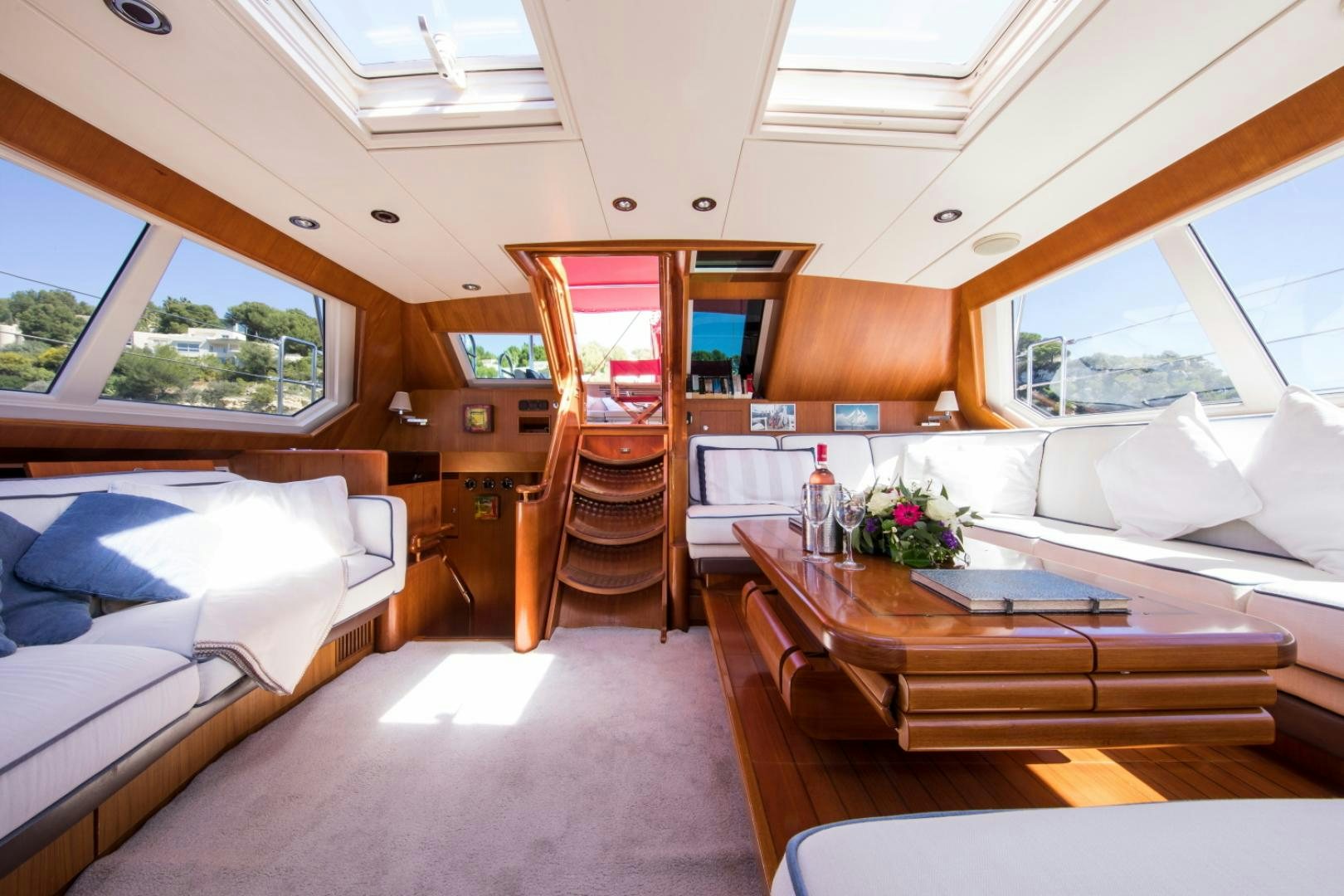 a room with a table and couch aboard ALTA MAREA Yacht for Sale