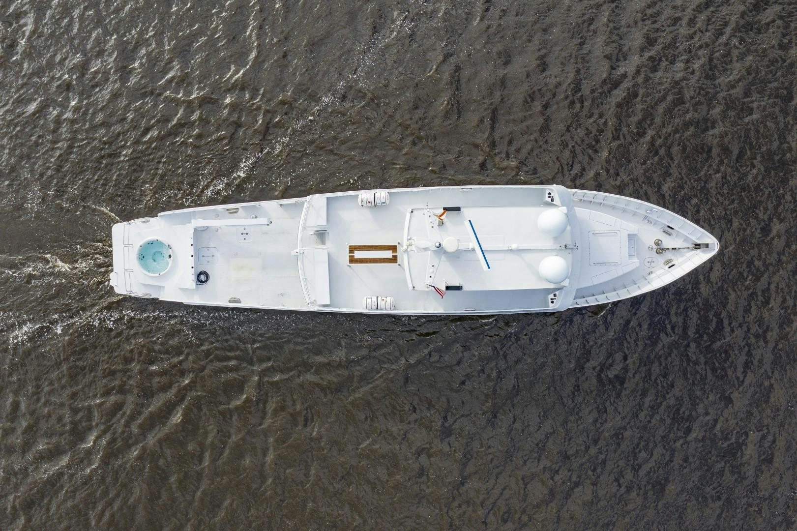 a white boat on a beach aboard RESET Yacht for Sale