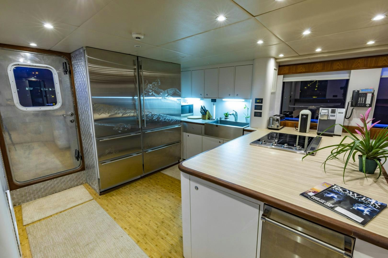 a kitchen with glass doors aboard RESET Yacht for Sale