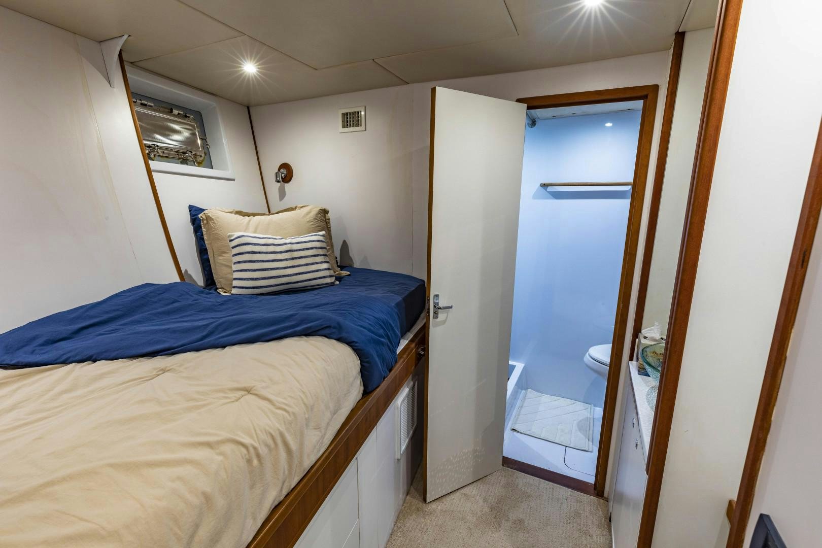 a bedroom with a bed and a door aboard RESET Yacht for Sale