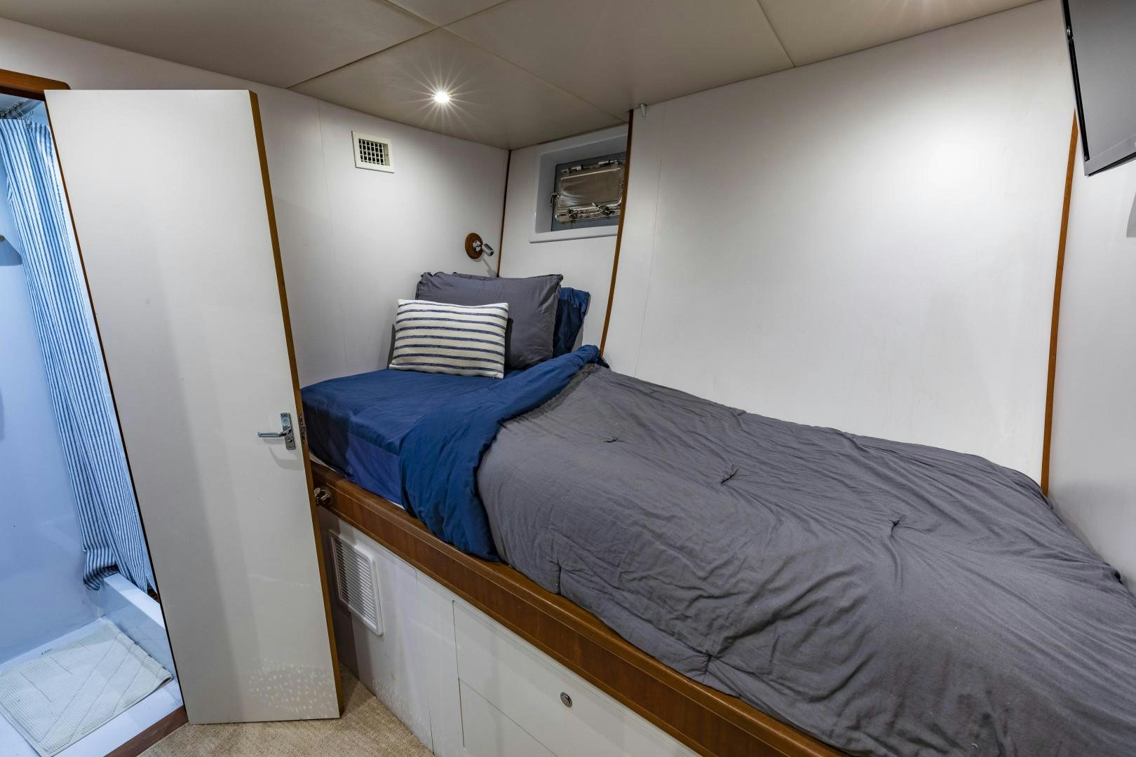 a bedroom with two beds aboard RESET Yacht for Sale