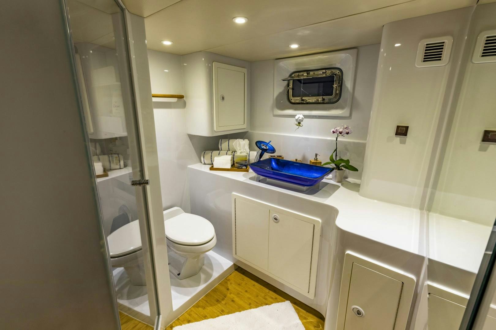 a bathroom with a glass shower aboard RESET Yacht for Sale