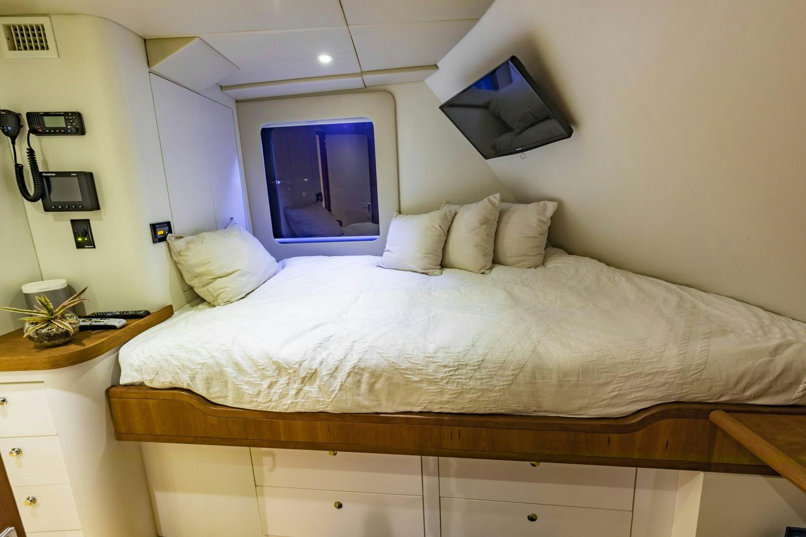 a bed with white sheets aboard RESET Yacht for Sale