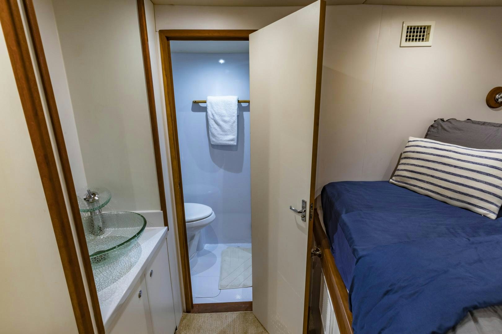 a bathroom with a sink and a bed aboard RESET Yacht for Sale