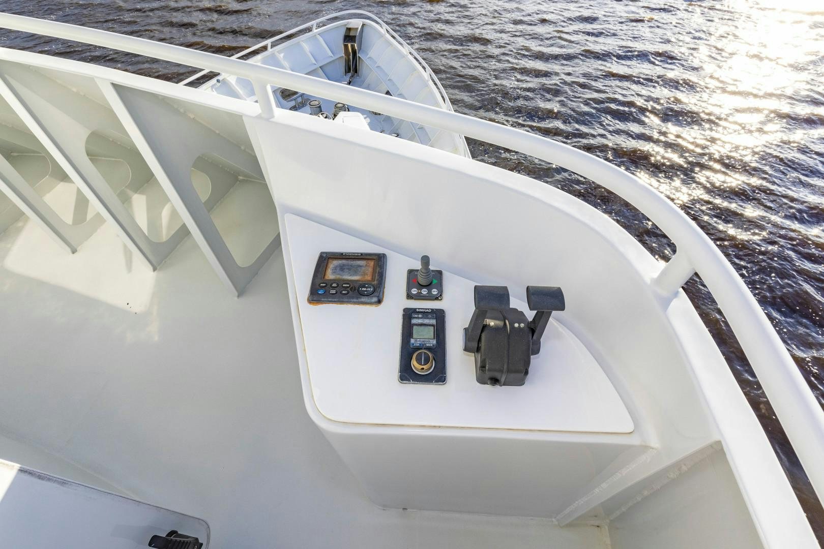 a white boat with black windows aboard RESET Yacht for Sale