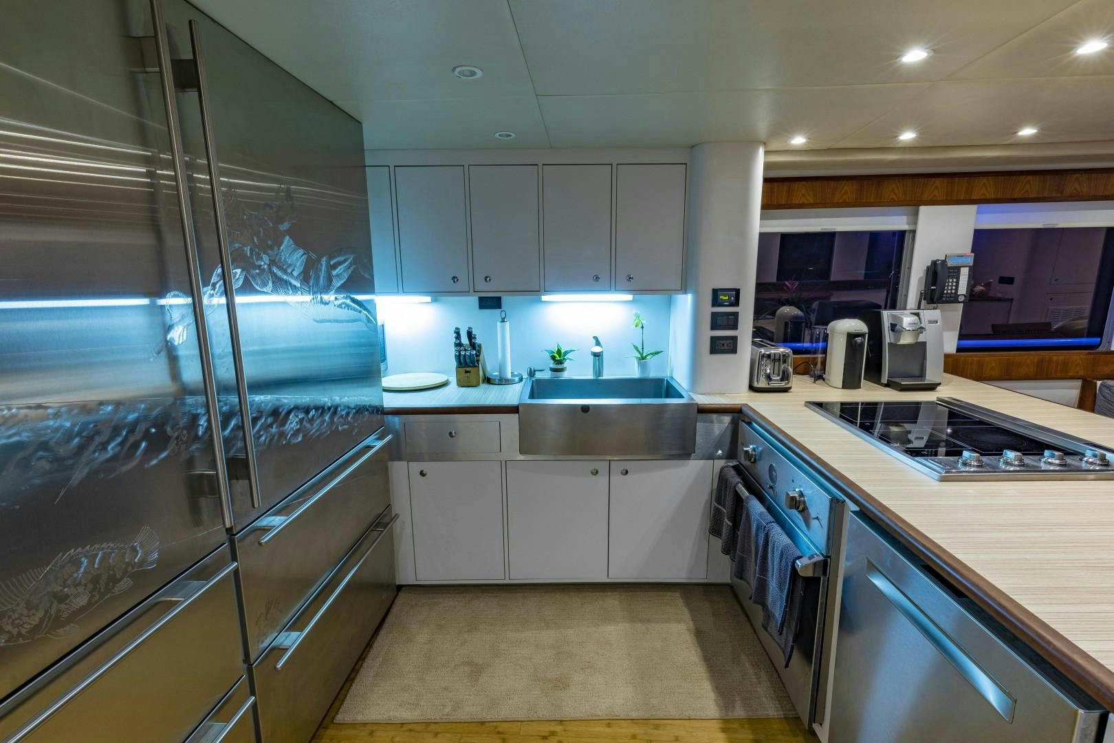 a kitchen with a glass door aboard RESET Yacht for Sale