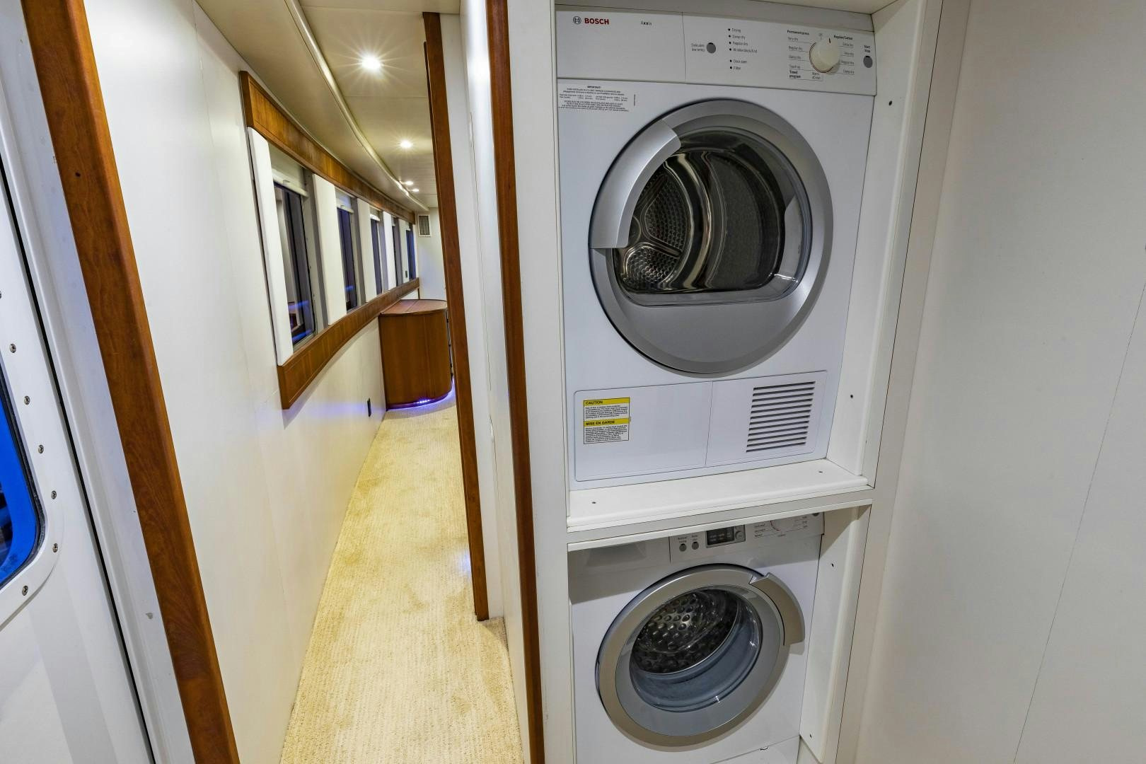 a room with a washing machine and dryer aboard RESET Yacht for Sale