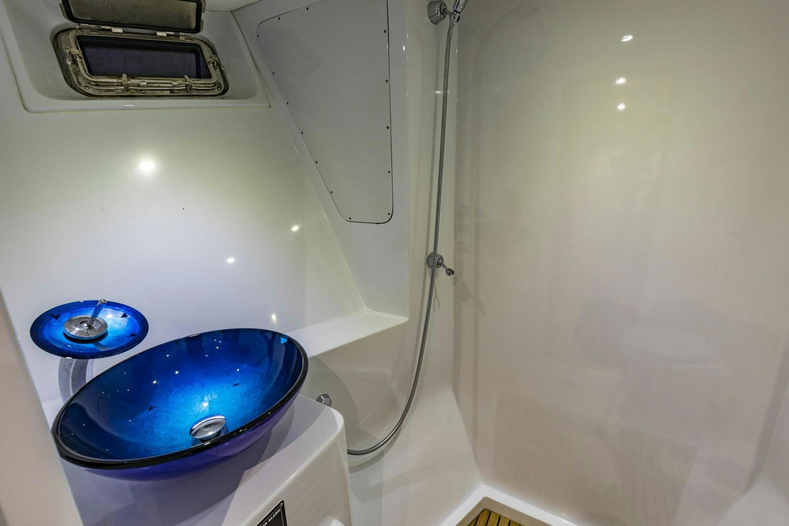 a blue bucket on a white surface aboard RESET Yacht for Sale