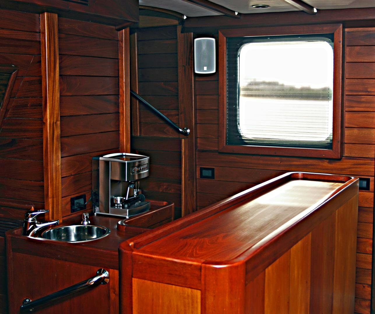 a kitchen with wooden cabinets aboard MESTRE BELO Yacht for Sale