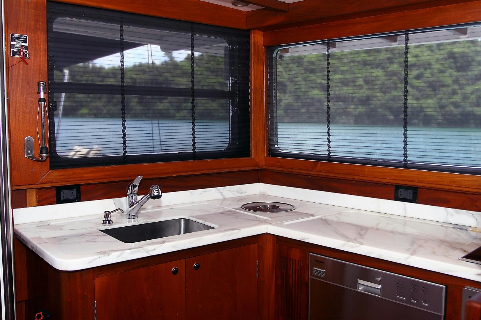 a kitchen with a sink and a window aboard MESTRE BELO Yacht for Sale