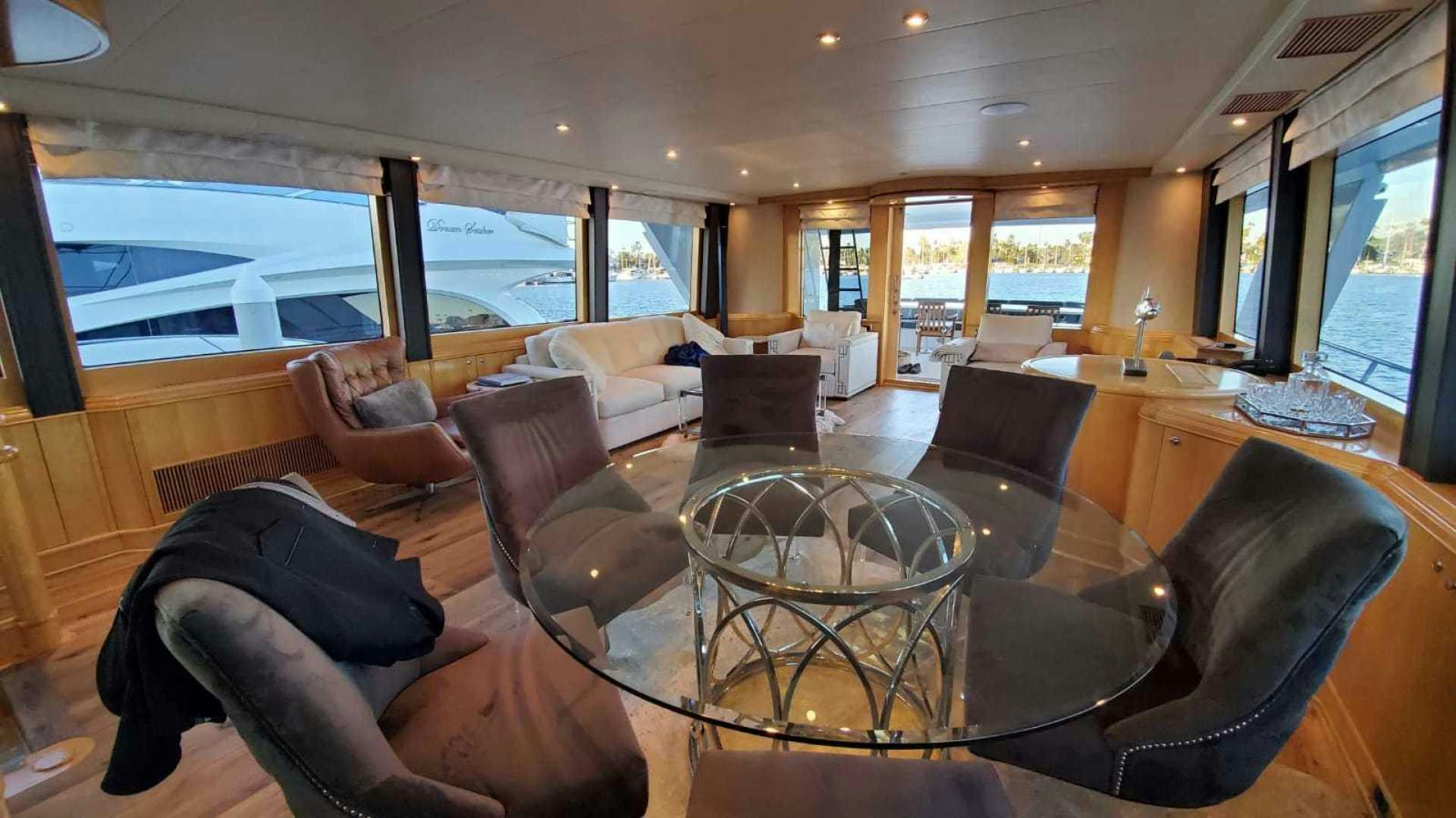 a room with a large glass window and a leather chair aboard LA LA LAND Yacht for Sale