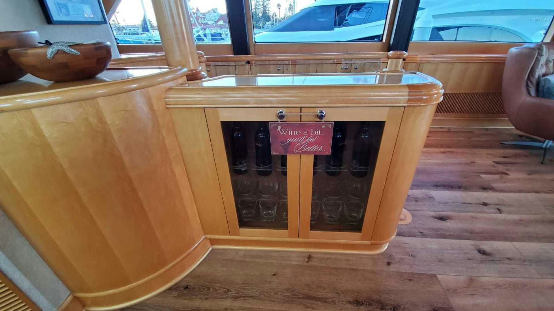 a wooden cabinet with a sign aboard LA LA LAND Yacht for Sale